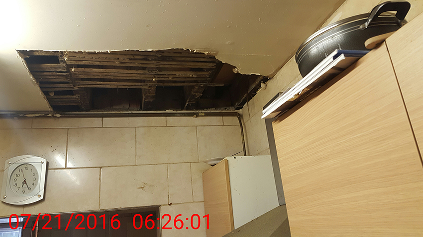 Brent Council housing raid - hole in ceiling - 2016